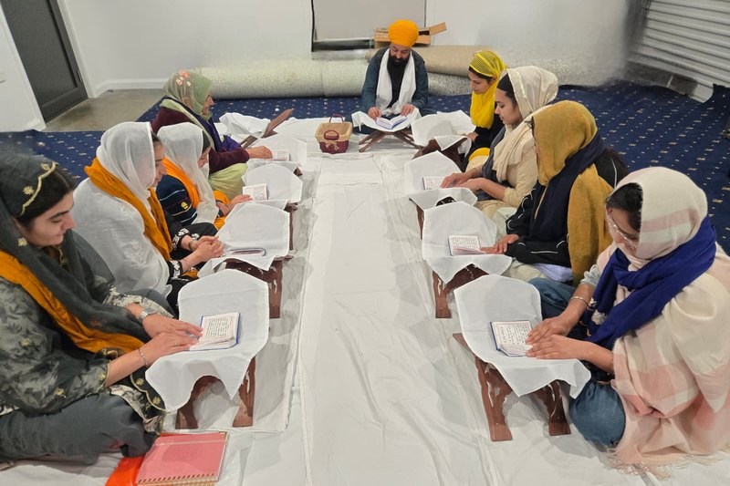 Sangat reading Gurbani together at the Saturday Santhya Class