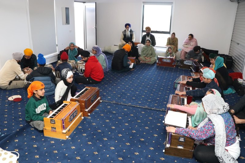 Sangat learning tabla and harmonium at the Kirtan Class